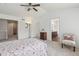 Bright main bedroom featuring vaulted ceilings, a ceiling fan, ensuite bath, and neutral carpeting at 2864 S Jebel Way, Aurora, CO 80013
