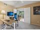 Bright office space with plush carpet, a large desk, and ample natural light from the adjacent living area at 2864 S Jebel Way, Aurora, CO 80013