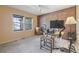 Cozy office space with ample natural light, exposed brick, and functional desk setup for productivity at 2864 S Jebel Way, Aurora, CO 80013