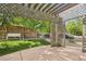 Covered patio area with a pergola, offering shade and an inviting outdoor space for relaxation and entertainment at 2864 S Jebel Way, Aurora, CO 80013