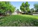 Expansive backyard featuring mature trees, a lawn, shed, and privacy fence at 11625 Bellaire Way, Thornton, CO 80233