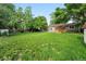 Spacious backyard with lush lawn, wooden fence, shed, and mature trees at 11625 Bellaire Way, Thornton, CO 80233