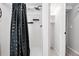 Bathroom with shower, white subway tile and black hardware at 11625 Bellaire Way, Thornton, CO 80233