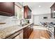 Kitchen with granite countertops and subway tile backsplash, leading to a dining area at 11625 Bellaire Way, Thornton, CO 80233