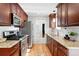Functional kitchen featuring modern appliances, granite countertops, and wood floors at 11625 Bellaire Way, Thornton, CO 80233