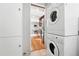 View into kitchen from the laundry closet with stacked washer and dryer at 11625 Bellaire Way, Thornton, CO 80233