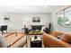 Inviting living room featuring modern furnishings, wood floors, and ample natural light at 11625 Bellaire Way, Thornton, CO 80233
