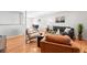 Bright living area featuring wood floors, comfortable seating, and neutral wall colors at 11625 Bellaire Way, Thornton, CO 80233