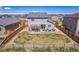 Large backyard with a patio, pergola, and stylish outdoor seating, enclosed by a wooden fence at 6954 E 117Th Ave, Thornton, CO 80233