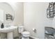 A simple yet elegant powder room with a modern pedestal sink and decor at 6954 E 117Th Ave, Thornton, CO 80233