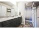 Bathroom with dual sinks, tile floors, and a shower-tub combination with a stylish shower curtain at 6954 E 117Th Ave, Thornton, CO 80233