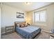 Well-lit bedroom with a cozy bed, large window, and stylish decor at 6954 E 117Th Ave, Thornton, CO 80233