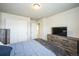 Comfortable bedroom featuring a large closet, soft lighting, and modern furniture at 6954 E 117Th Ave, Thornton, CO 80233