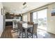 Open-concept dining area with a stylish light fixture, dark cabinets, and a sliding door to the backyard at 6954 E 117Th Ave, Thornton, CO 80233