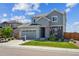 Beautifully landscaped two-story home featuring a two-car garage and a welcoming front yard at 6954 E 117Th Ave, Thornton, CO 80233