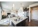 Open-concept kitchen with large island, stainless steel appliances, flowing into the living area at 6954 E 117Th Ave, Thornton, CO 80233