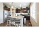 Stylish kitchen with granite countertops, a breakfast bar, modern stainless steel appliances, and dark cabinets at 6954 E 117Th Ave, Thornton, CO 80233