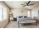 Comfortable main bedroom with a ceiling fan, carpeting, ample natural light, and neutral decor at 6954 E 117Th Ave, Thornton, CO 80233