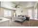 Spacious main bedroom features a ceiling fan, carpet, lots of natural light, and neutral color scheme at 6954 E 117Th Ave, Thornton, CO 80233