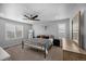 Spacious main bedroom featuring a ceiling fan, plush carpeting, and plantation shutters for privacy at 6954 E 117Th Ave, Thornton, CO 80233