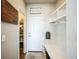 Practical mud room featuring built-in bench, storage, and welcoming decor at 6954 E 117Th Ave, Thornton, CO 80233