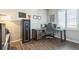 Office with wood floors featuring desk, office chair, safe and window with modern shutters at 6954 E 117Th Ave, Thornton, CO 80233