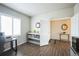 Home office featuring wood floors, modern decor, and natural light at 6954 E 117Th Ave, Thornton, CO 80233