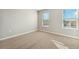 Bright bedroom with carpet, neutral walls and two windows providing natural light at 2974 Oxley St, Strasburg, CO 80136