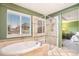 Bathroom with soaking tub, glass shower, and views of the neighborhood at 10247 Telluride Way, Commerce City, CO 80022