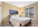 This bedroom features soft yellow walls, carpet floors, a window, and an entertainment center at 10247 Telluride Way, Commerce City, CO 80022