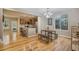 Open-concept dining area adjacent to kitchen with hardwood floors and lots of light at 10247 Telluride Way, Commerce City, CO 80022