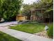 Two story home with golden yellow siding, concrete driveway, a two car garage and manicured lawn at 10247 Telluride Way, Commerce City, CO 80022