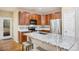 Kitchen featuring dark wood cabinets, granite countertops, and stainless steel appliances at 10247 Telluride Way, Commerce City, CO 80022