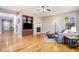 Bright living room showcasing hardwood floors, a fireplace, and built-in shelving at 10247 Telluride Way, Commerce City, CO 80022