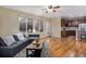 Open living room featuring hardwood floors, large windows, and a gray sectional sofa at 10247 Telluride Way, Commerce City, CO 80022