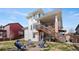 Backyard with a cozy fire pit, Adirondack chairs, a deck with stairs, and a white exterior at 4464 E 139Th Ave, Thornton, CO 80602