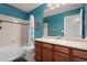 Charming bathroom with a white tub, blue walls, nautical decor and white cabinets at 4464 E 139Th Ave, Thornton, CO 80602