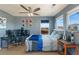 Comfortable bedroom with blue walls, two windows, a ceiling fan, and workspace with computer setup at 4464 E 139Th Ave, Thornton, CO 80602