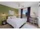 Cozy bedroom with stylish decor, including plants, soft lighting, a comfortable bed, and outside view at 4464 E 139Th Ave, Thornton, CO 80602