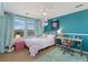 Stylish bedroom features bright blue walls, plush carpet, and a cozy bed with pastel decor at 4464 E 139Th Ave, Thornton, CO 80602