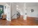 Bright entryway with hardwood floors, staircase, and glimpses into the living spaces at 4464 E 139Th Ave, Thornton, CO 80602