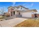 Charming two-story home with a brick facade and a two-car garage and covered front porch at 4464 E 139Th Ave, Thornton, CO 80602