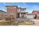 Contemporary two-story home with brick accents, covered porch and attached two car garage at 4464 E 139Th Ave, Thornton, CO 80602