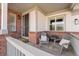 Cozy front porch with seating area, decorative pillows, and a welcoming entrance at 4464 E 139Th Ave, Thornton, CO 80602