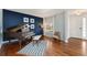 Cozy living room features a piano, large window, and a comfortable chair at 4464 E 139Th Ave, Thornton, CO 80602