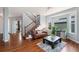 Bright and airy living room with hardwood floors, a staircase, and large windows at 4464 E 139Th Ave, Thornton, CO 80602