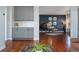Elegant living room featuring hardwood floors, a built in bar, and a grand piano at 4464 E 139Th Ave, Thornton, CO 80602