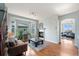 Inviting living room features a cozy fireplace, hardwood floors, and ample natural light from a bay window at 4464 E 139Th Ave, Thornton, CO 80602