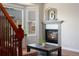 Close up of cozy living room with fireplace, hardwood floors, and abundant natural light from a bay window at 4464 E 139Th Ave, Thornton, CO 80602