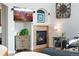 Comfortable living room featuring a fireplace, a mounted TV, and stylish decor at 4464 E 139Th Ave, Thornton, CO 80602